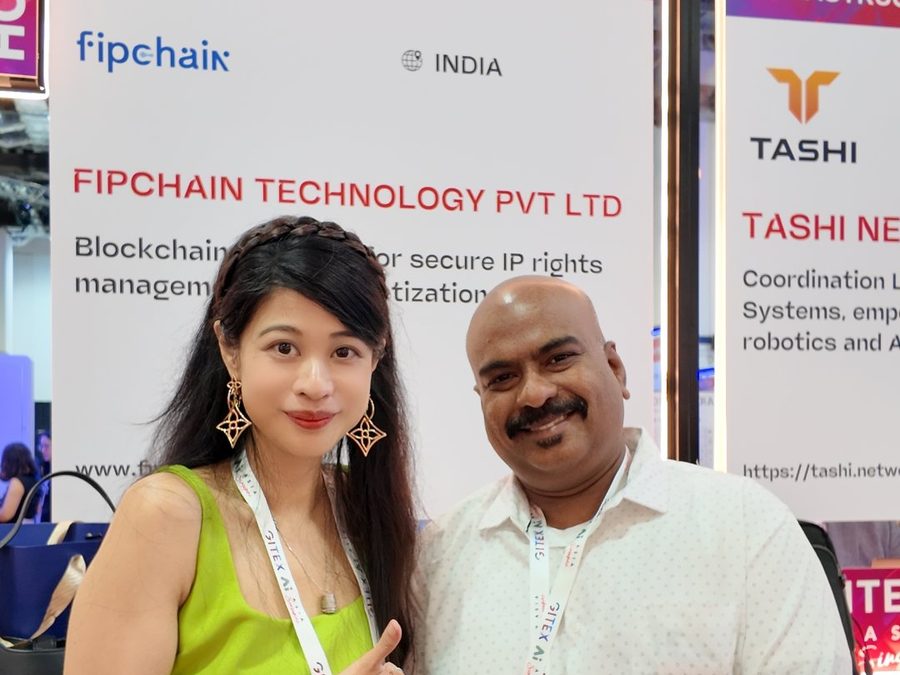 Web3Plus co-founder with an exhibitor at the GITEX Asia startup pavilion in Singapore